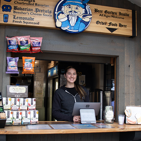 München Haus employee standing at the ordering stand.