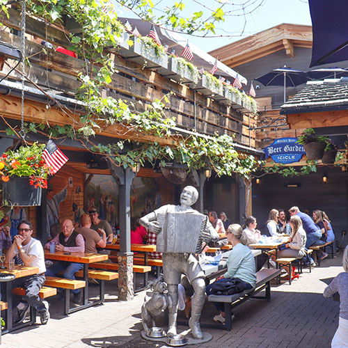 View of the beer garden with people eating and drinking.